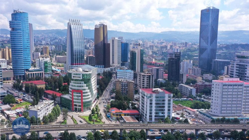 An aerial view of the Addis Ababa skyline, high-rise towers rising above the ring road.